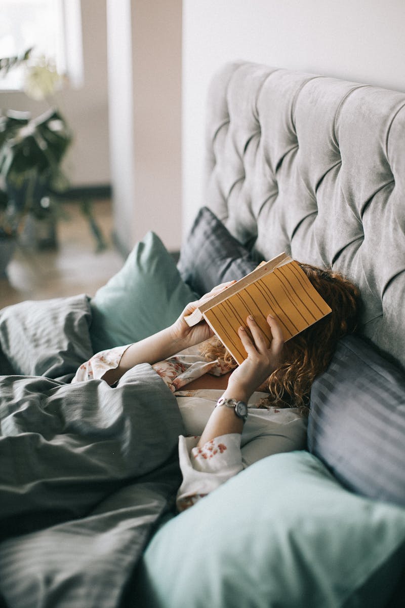 Woman Covering Face With Book