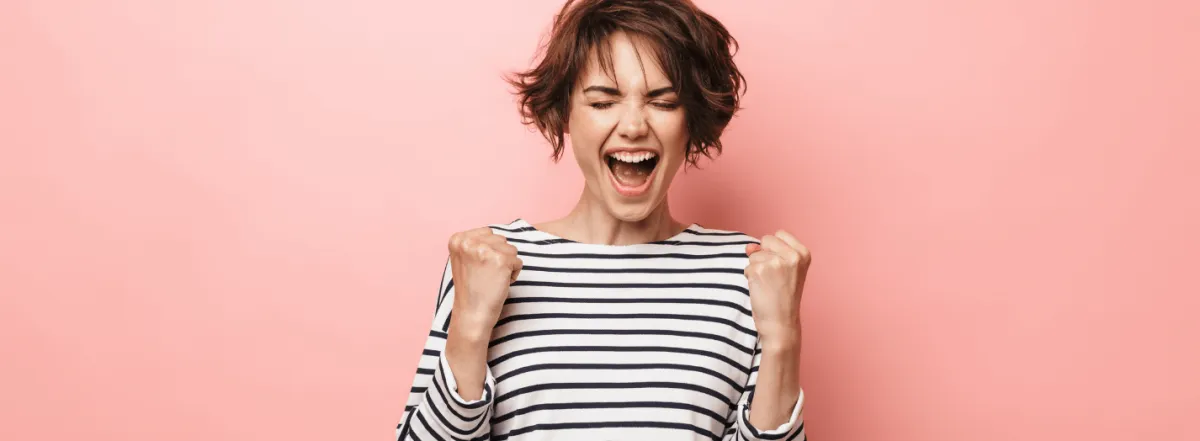 Woman doing an excited fist bump to crush content marketing overwhelm