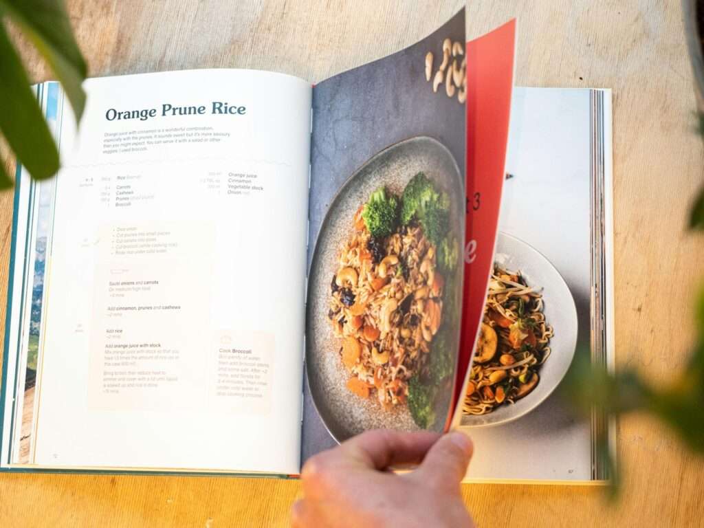 Hand turning pages in a cookbook