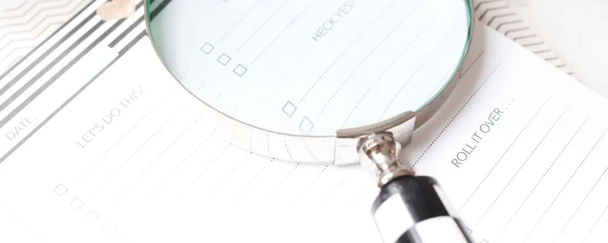 magnifying glass on a day planner highlighting a keyword