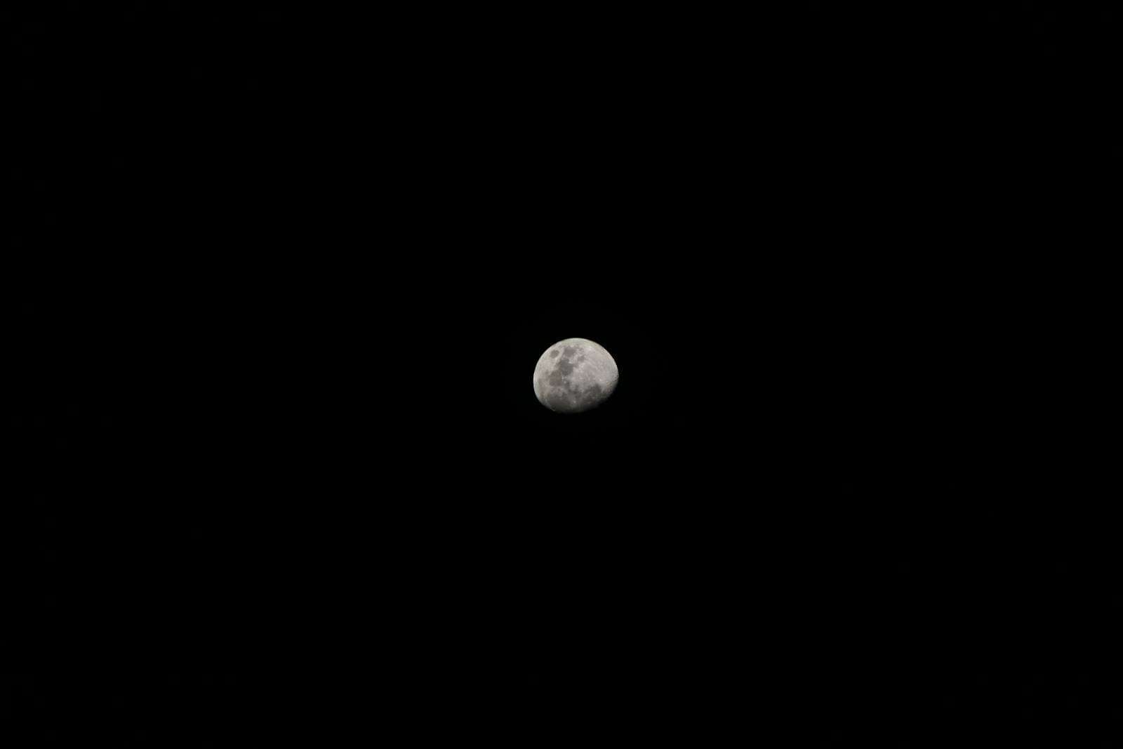 silver moon against a black sky meaning of black color