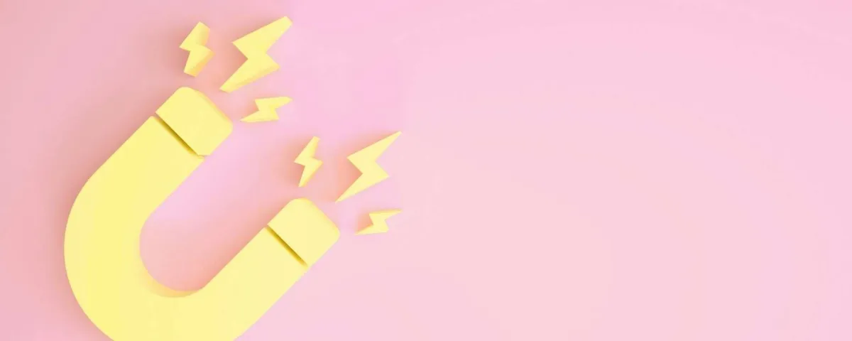 graphic illustration of a yellow magnet on a pink background for blog post "How to Deliver & Promote Your Lead Magnet"