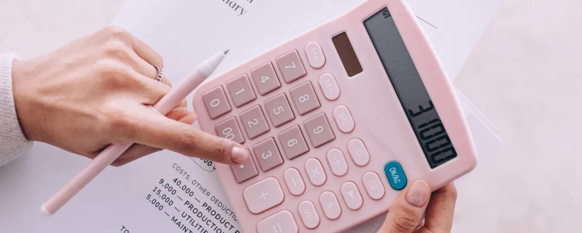 how to price your coaching services: a life coach using a calculator