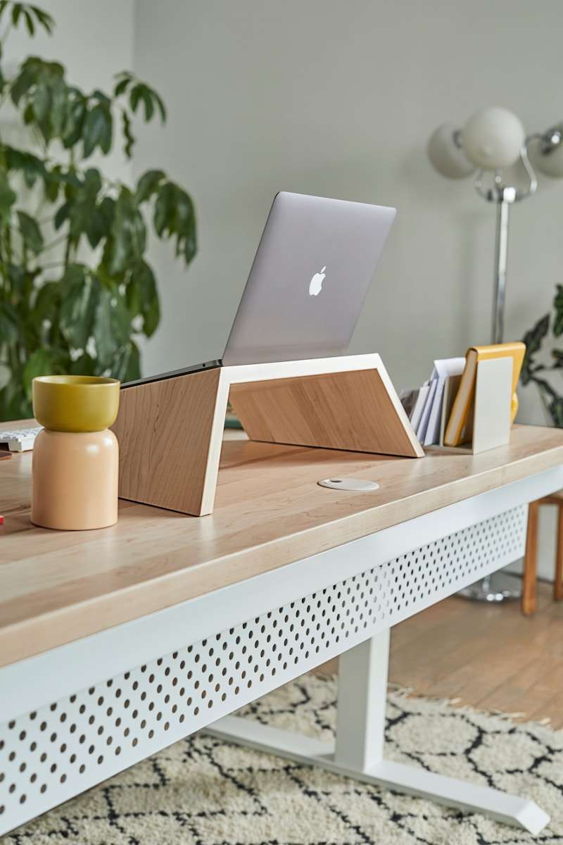 minimalist home office with laptop and journal, tools to create long-form content for coaches