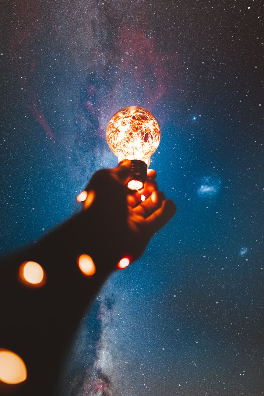 Person holding a light blub representing genius content.