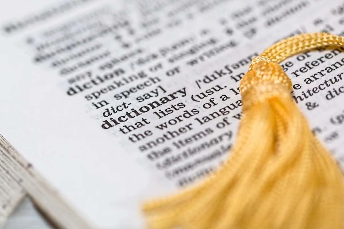 Photo of a dictionary with a yellow bookmark tassle