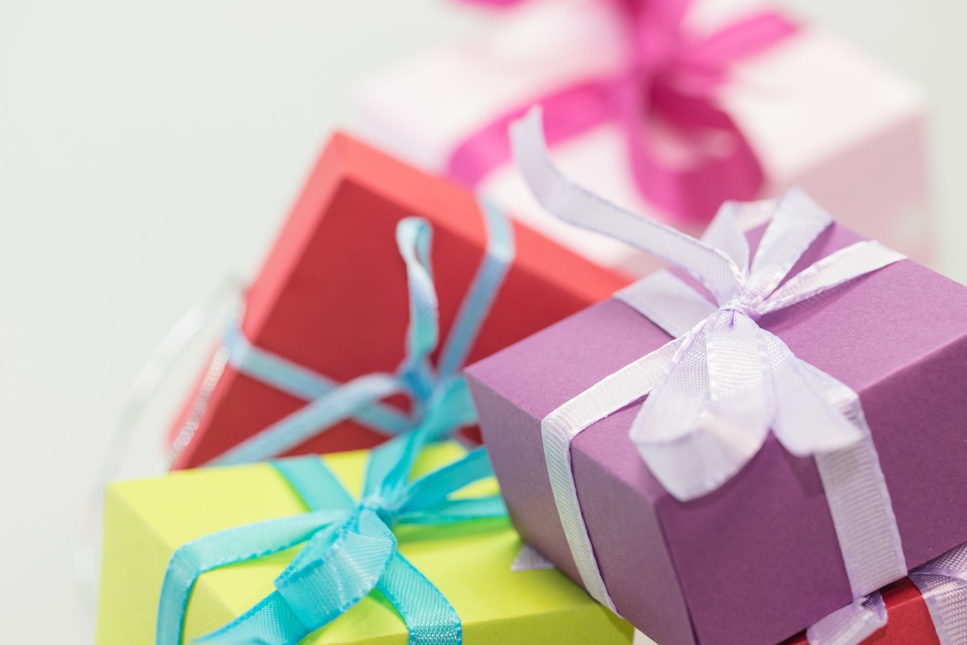A pile of wrapped gifts with colorful paper and ribbons to represent the gifts people give away in a marketing bundle.