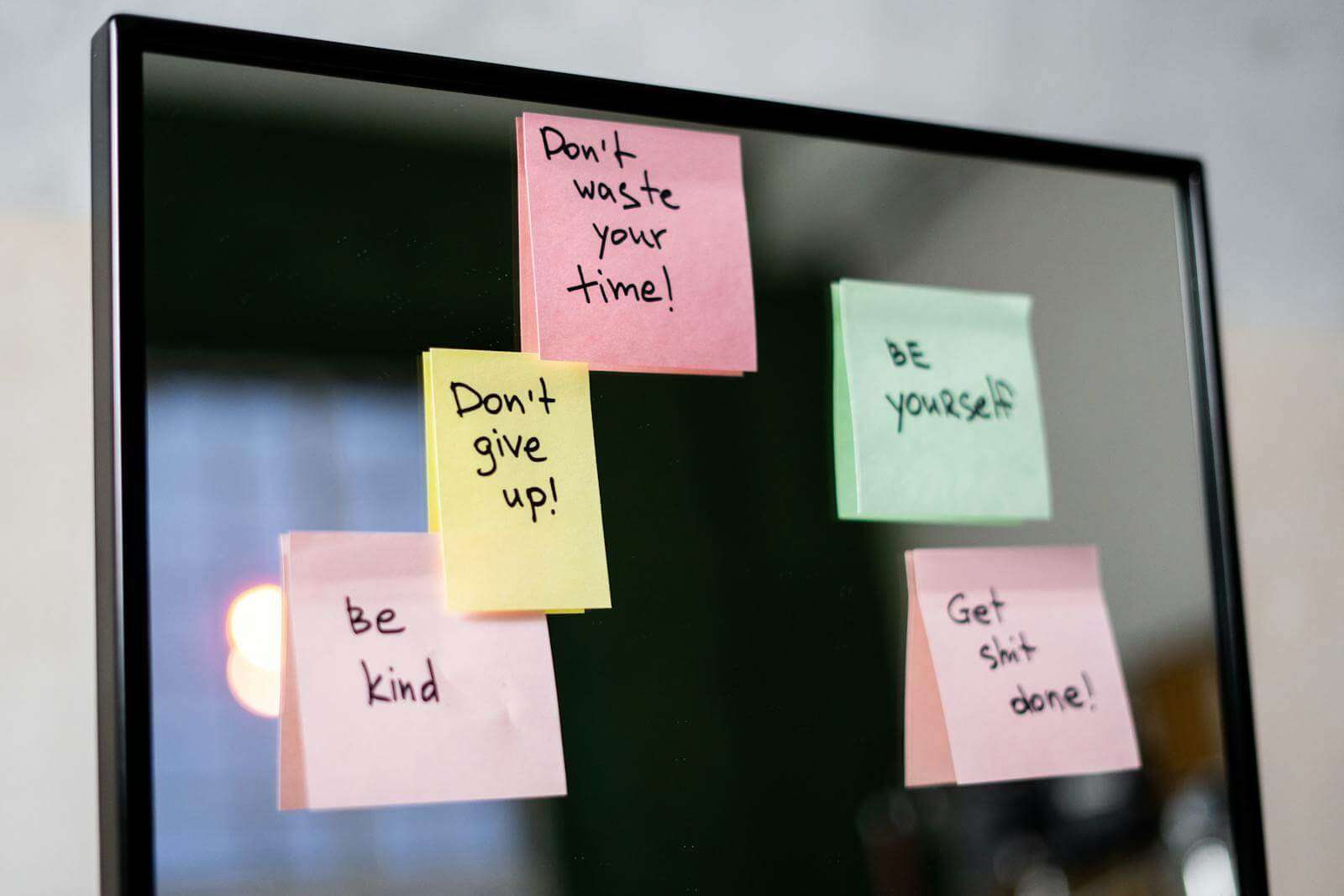 Sticky Notes with Affirmations on Glass Wall