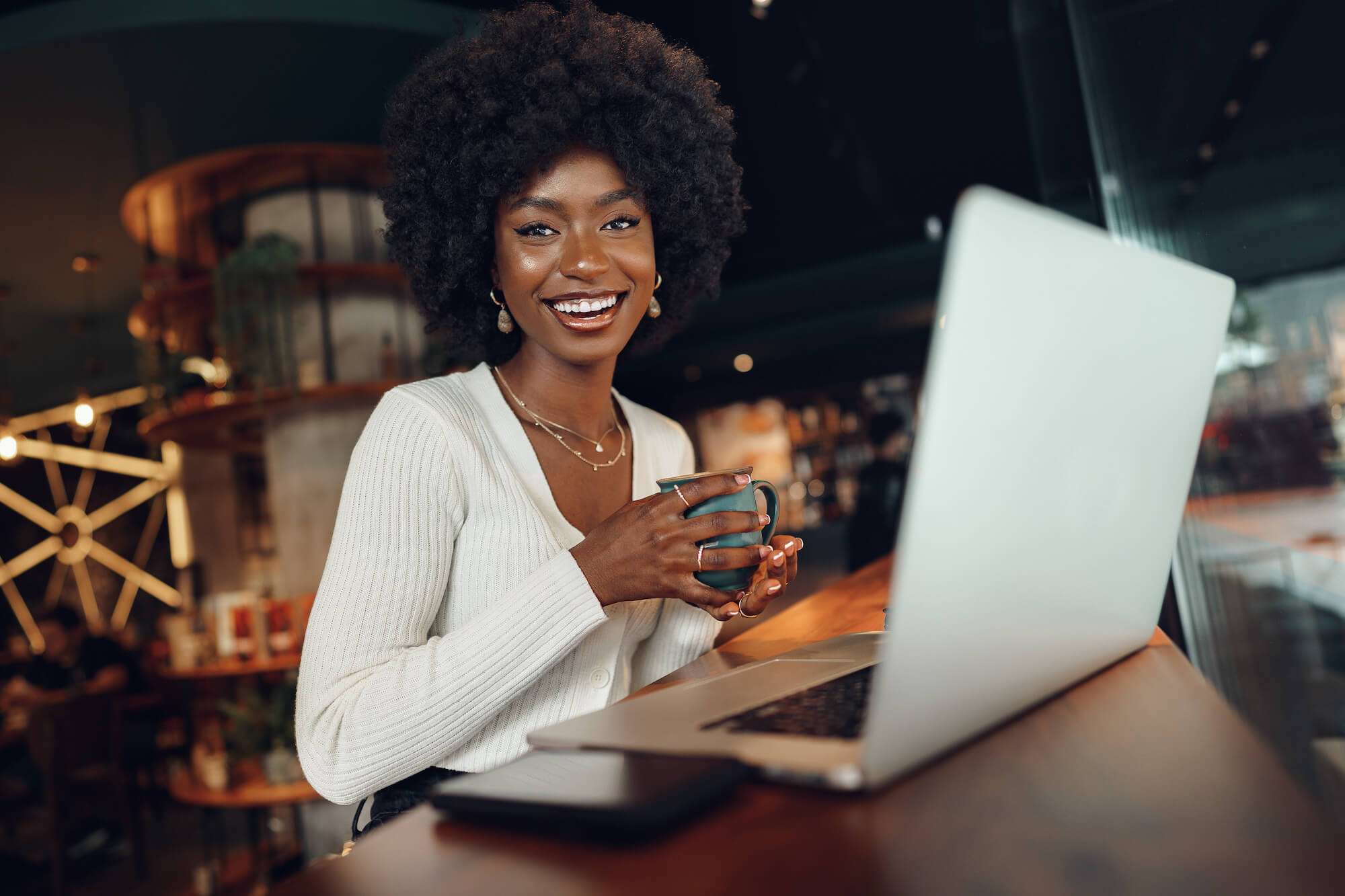 Happy woman business owner working at laptop on website design and marketing strategy