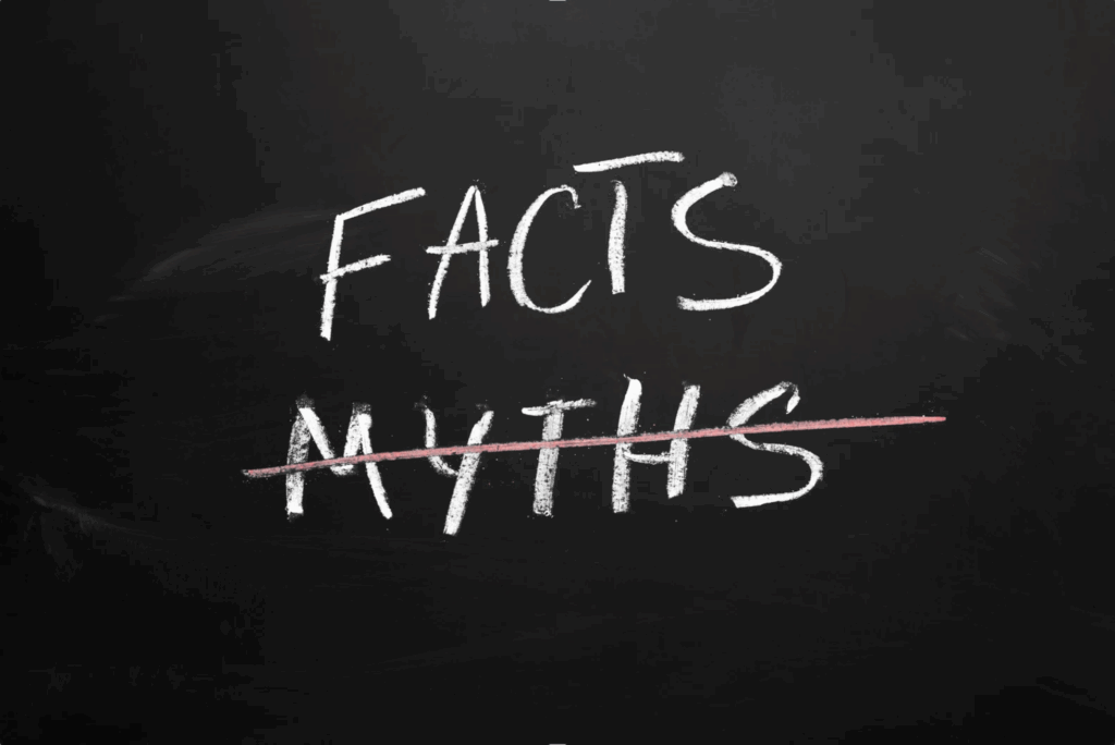 black chalkboard with facts and myths written on it - myths is crossed out.