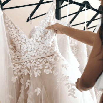 woman looking for wedding dresses on a rack