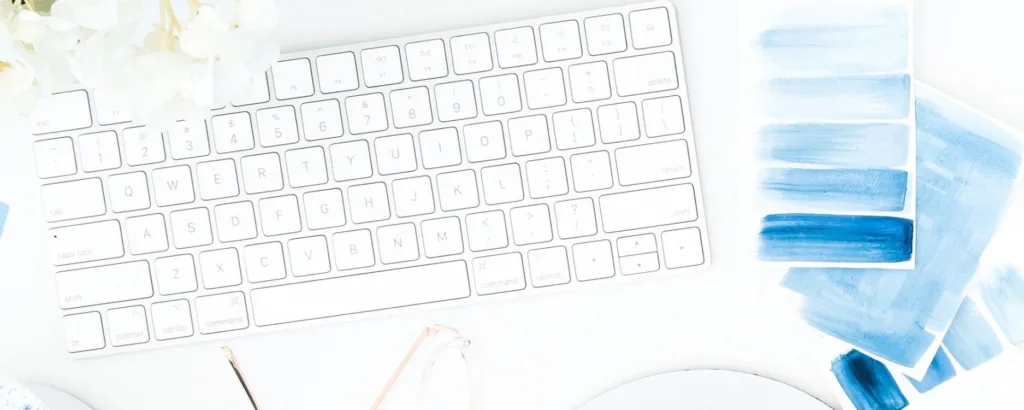 keyboard, watercolor paint swatches in shades of blue