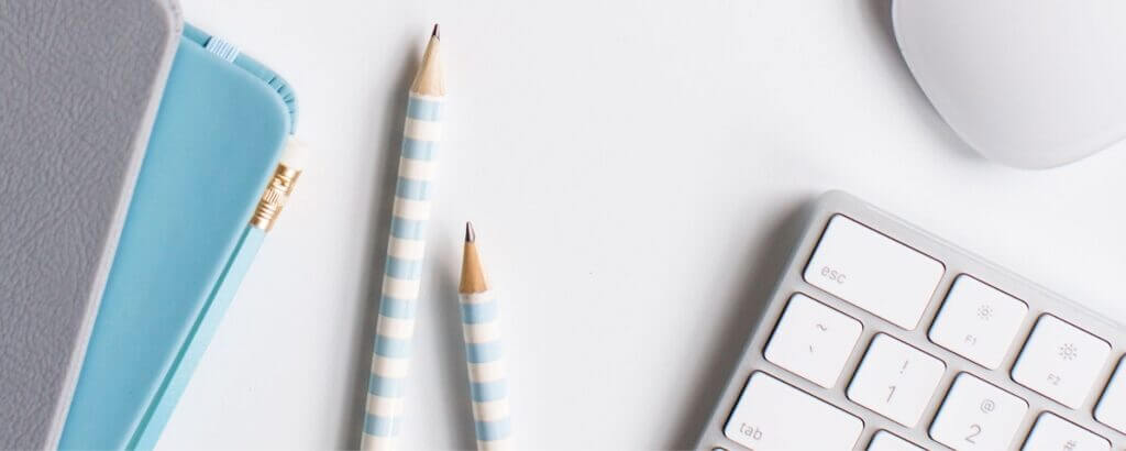 keyboard pencils and notebooks