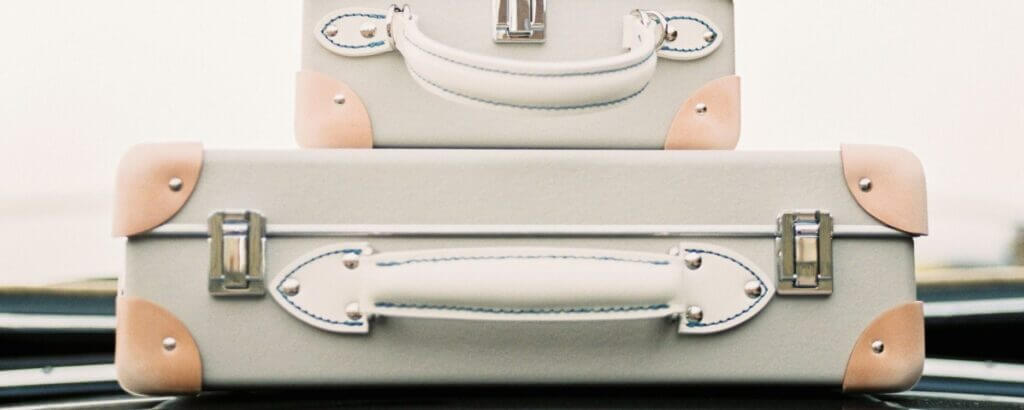 suitcases piled on top of a car