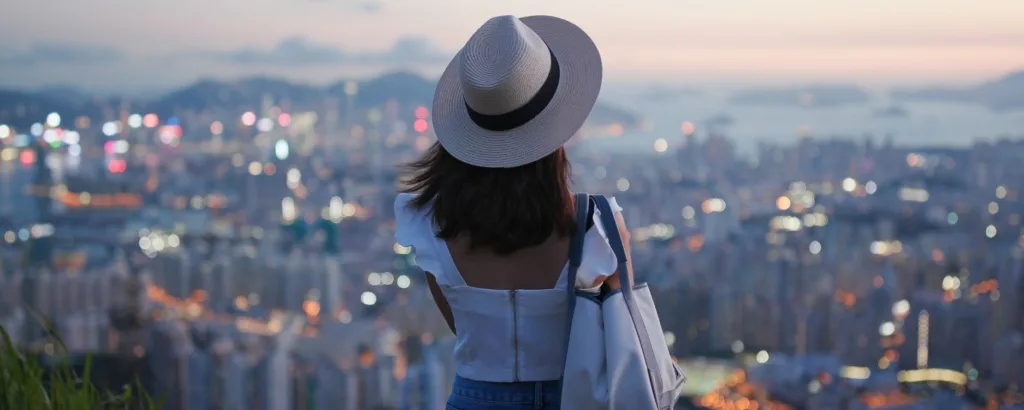 woman looking at the skyline of a city that looks hazy in the background