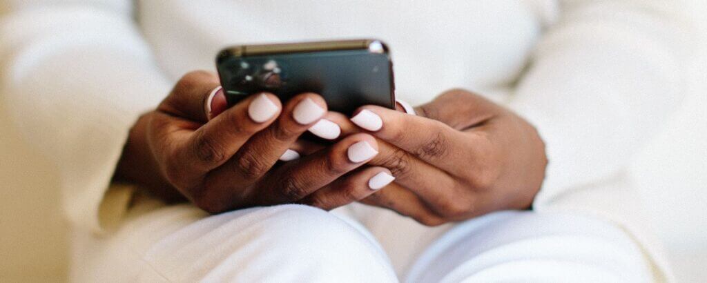 woman's hands holding a cell phone