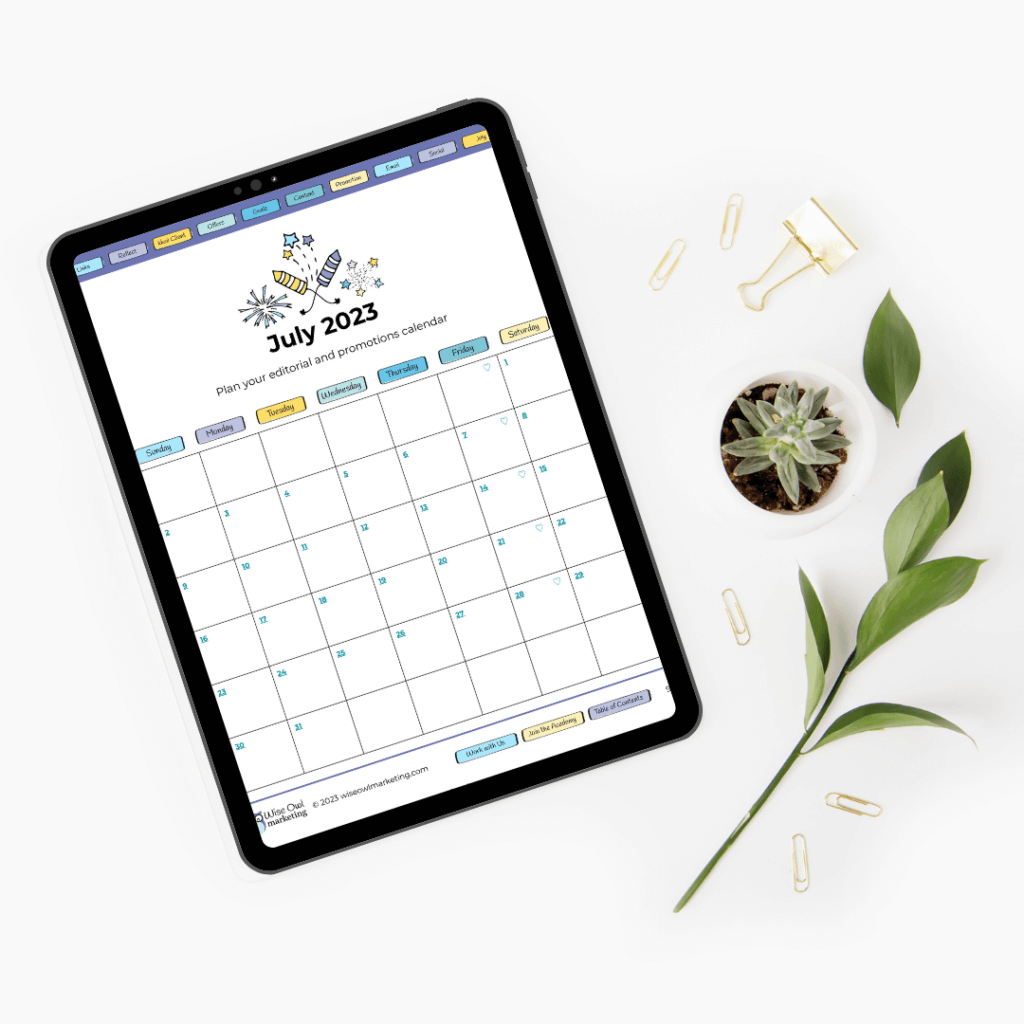 An iPad mock up of the 5-minute marketing planner showing an example of the calendar page with interactive links. There are also leaves, a plant, and paper clips in on the desk.