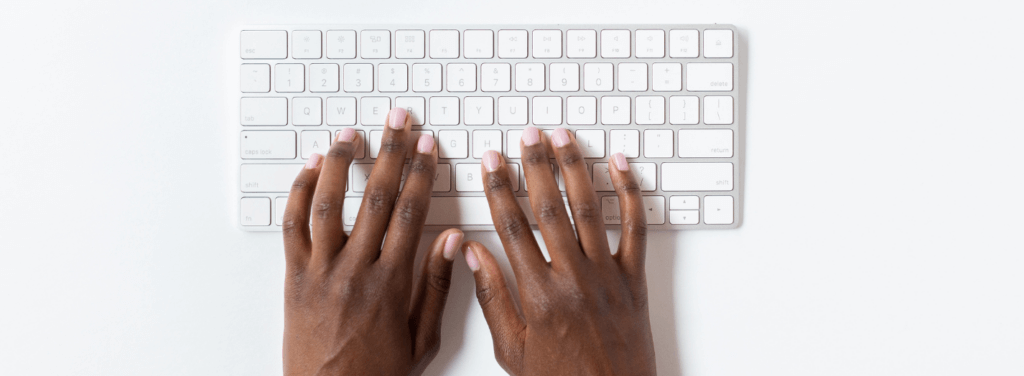 Hands typing on a keyboard
