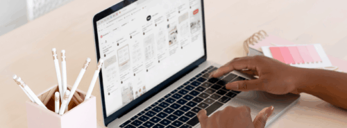 Hands typing on a keyboard as someone is building a website