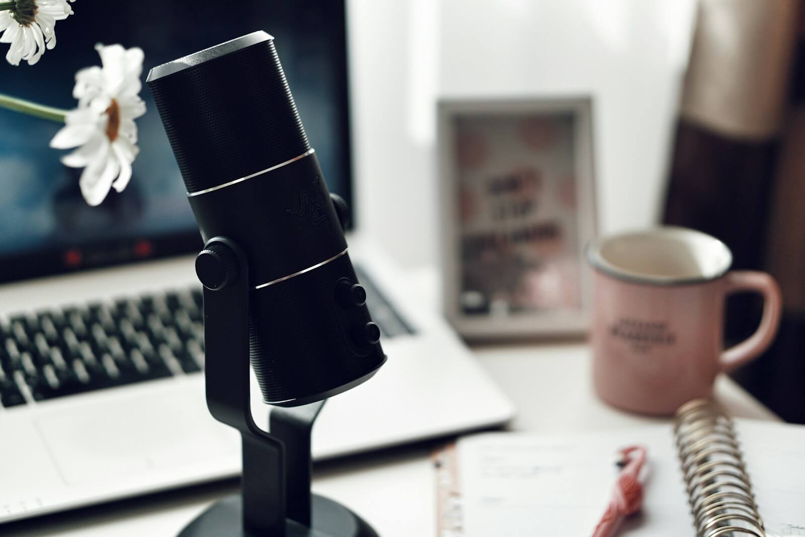 black and silver stand mic on a desk with a laptop