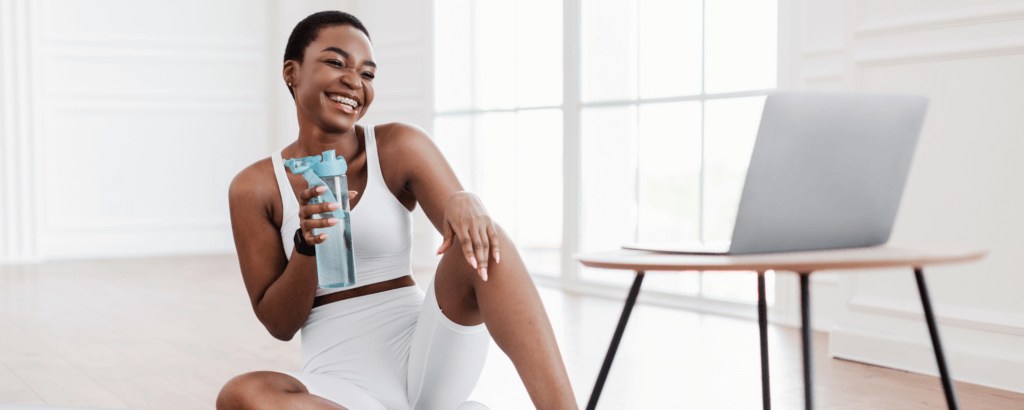 A health coach helping a client virtually with a laptop on the table.