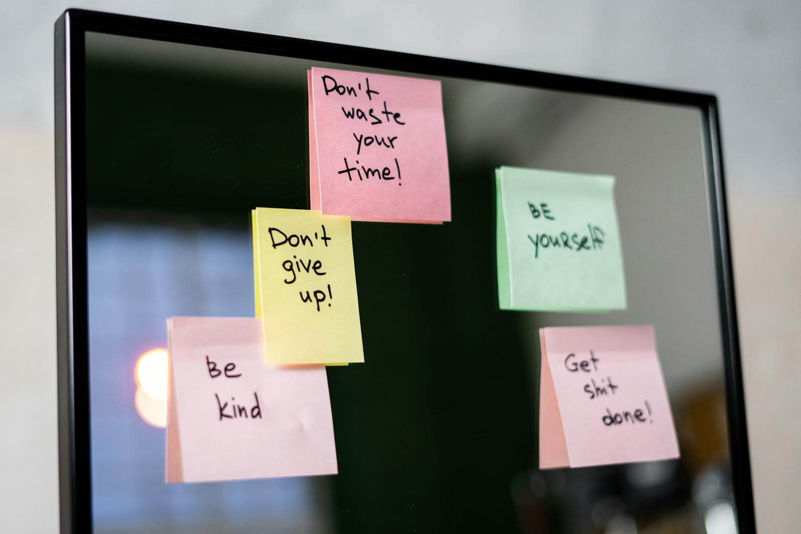 Sticky Notes with Affirmations on Glass Wall