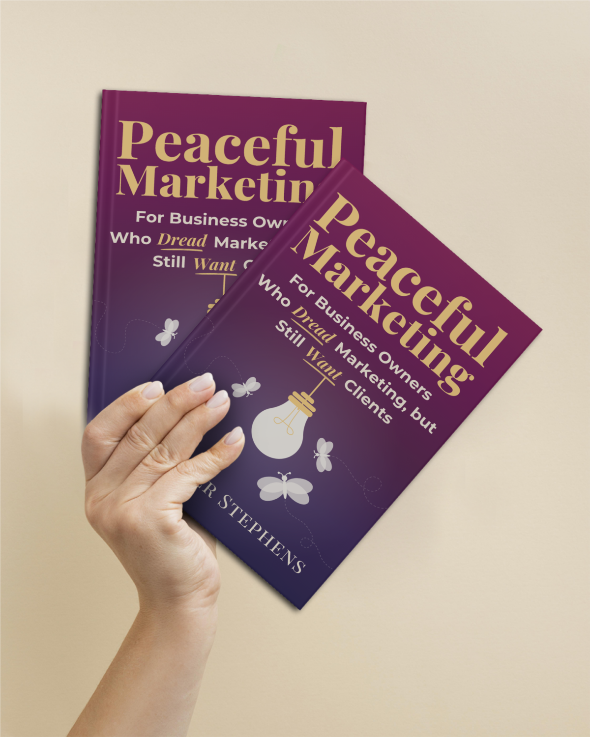 woman holding 2 copies of the Peaceful Marketing Book by Heather Stephens