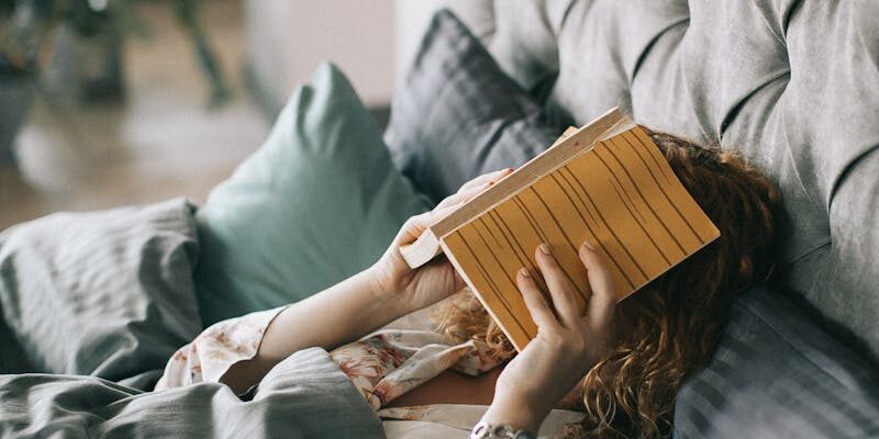 Woman Covering Face With Book