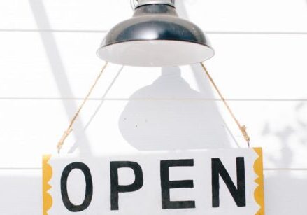 open sign hanging from a farmhouse style outdoor light