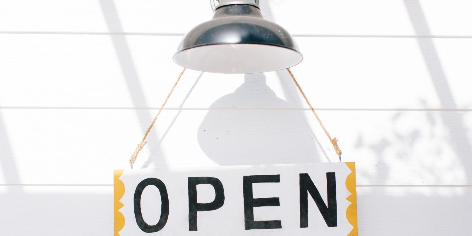 open sign hanging from a farmhouse style outdoor light