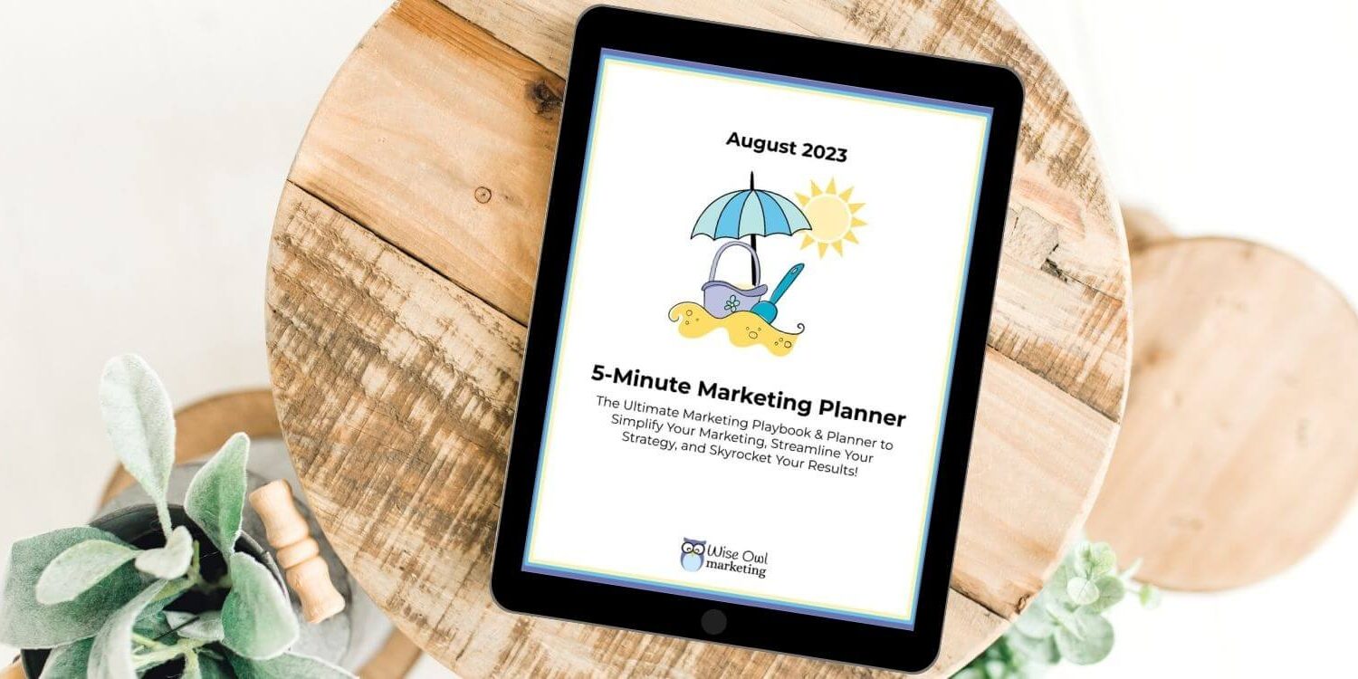 a round wooden table with an ipad on top showing the 5-minute marketing planner on the screen