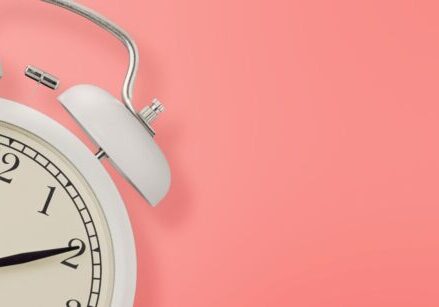 alarm clock on a pink background for blog post image " 5 Easy Ways to Find Time to Build Your Funnel When You’re Already Overbooked"
