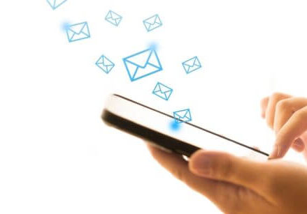 isolated image of a pair of hands scrolling through a phone with email envelopes floating out of it