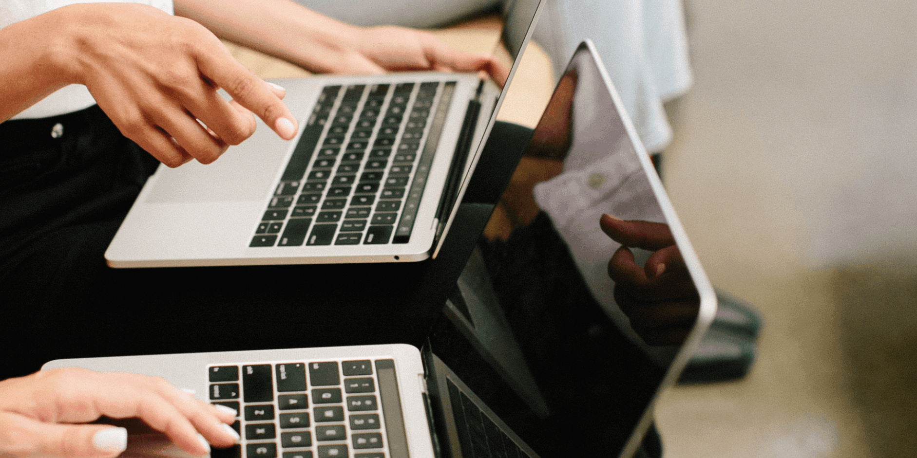 Two people working on laptops doing social media marketing