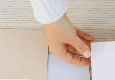 Hands choosing a color swatch to represent cognitive bias in decision-making