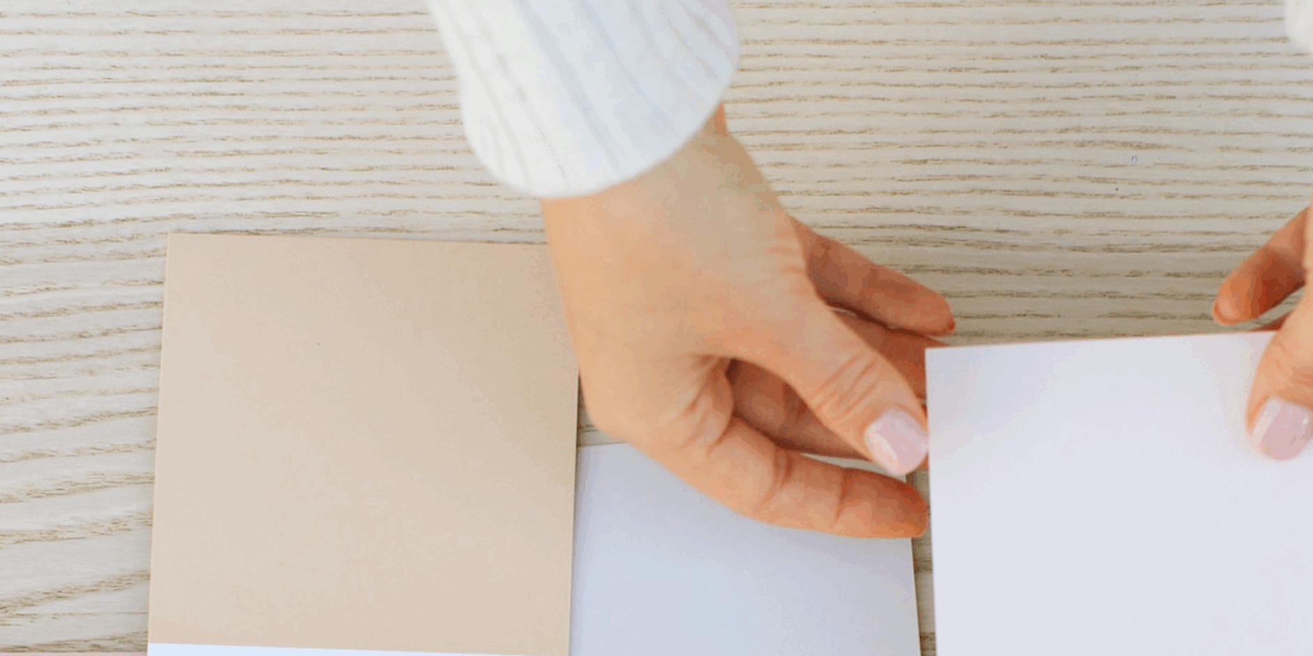 Hands choosing a color swatch to represent cognitive bias in decision-making