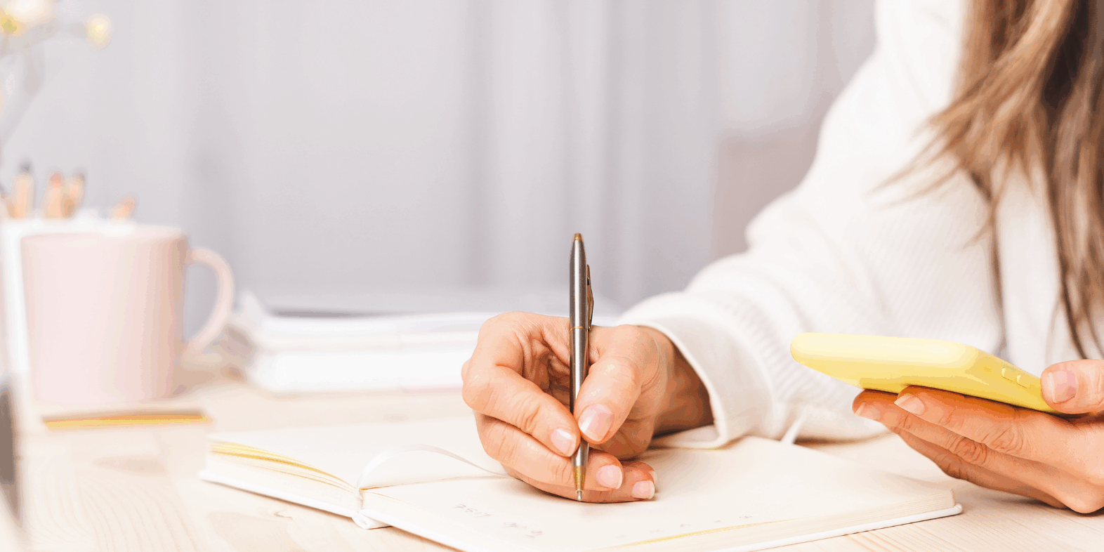 Female business owner sitting at her desk planning her marketing