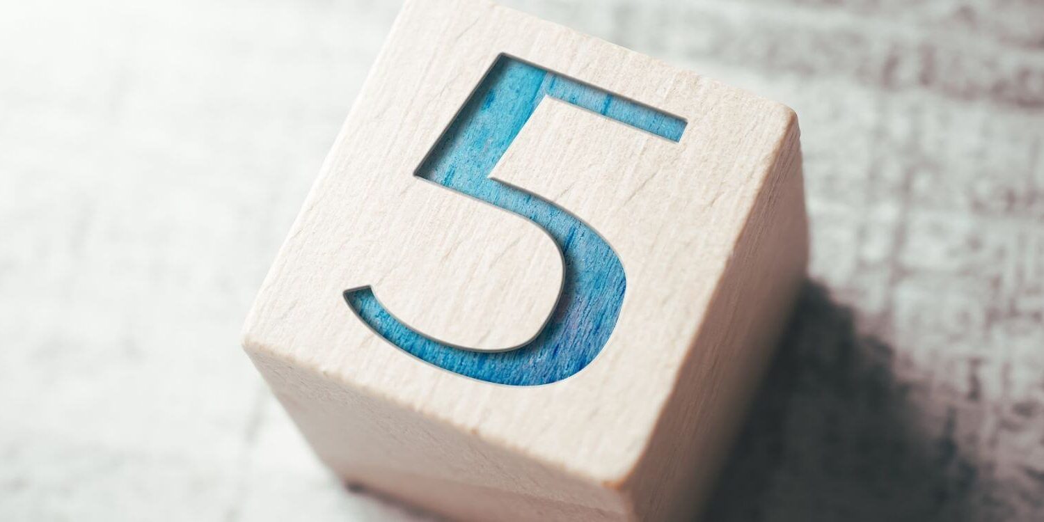 wooden block with the number 5 stamped into it and painted turquoise