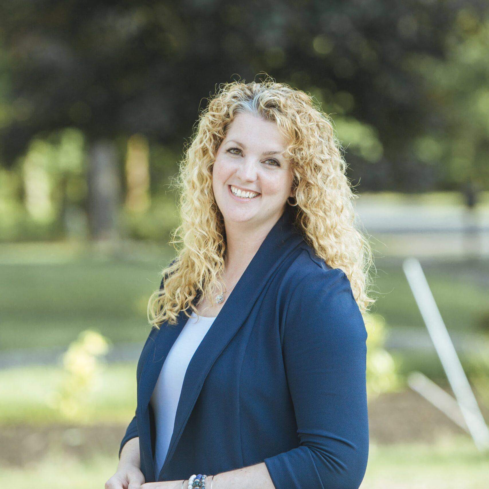 Picture of Deana Farrell, a blonde white woman with long curly hair