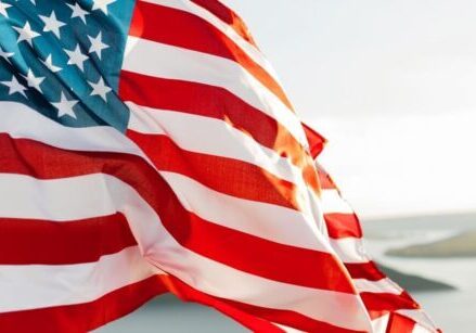 closeup of an American flag blowing in the wind