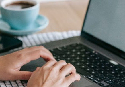 woman typing on laptop writing a blog