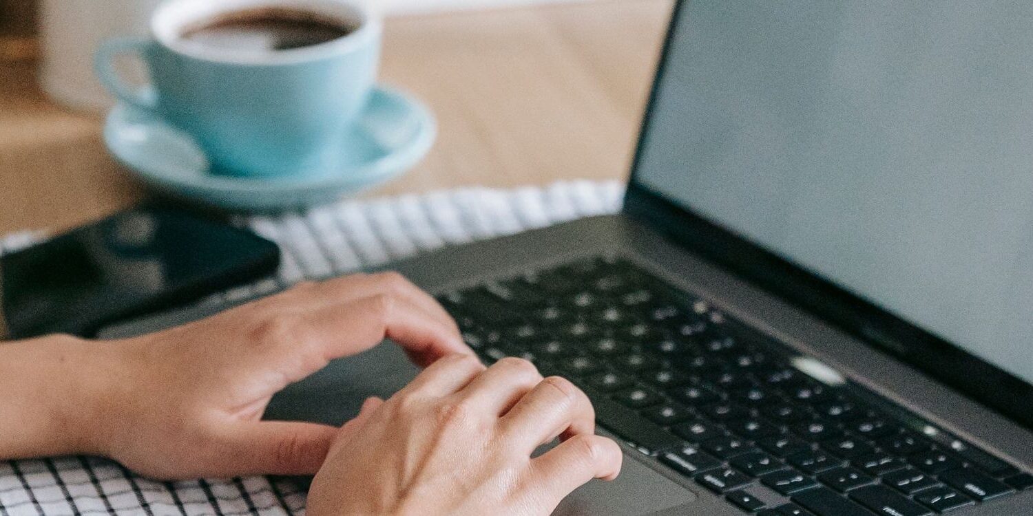 woman typing on laptop writing a blog