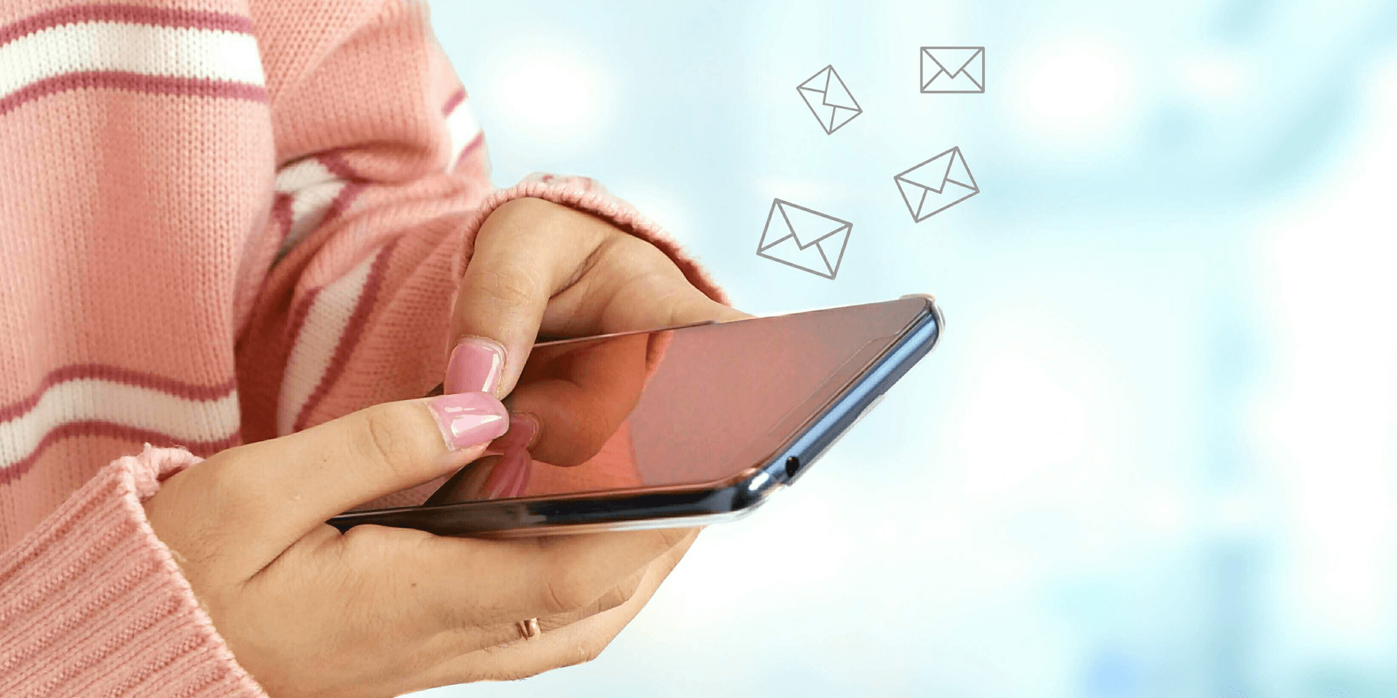 photo of a woman's hands holding a cell phone with envelope icons floating off the screen to represent effective email marketing