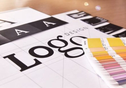 drawing of letters that say LOGO with a fan of color swatches