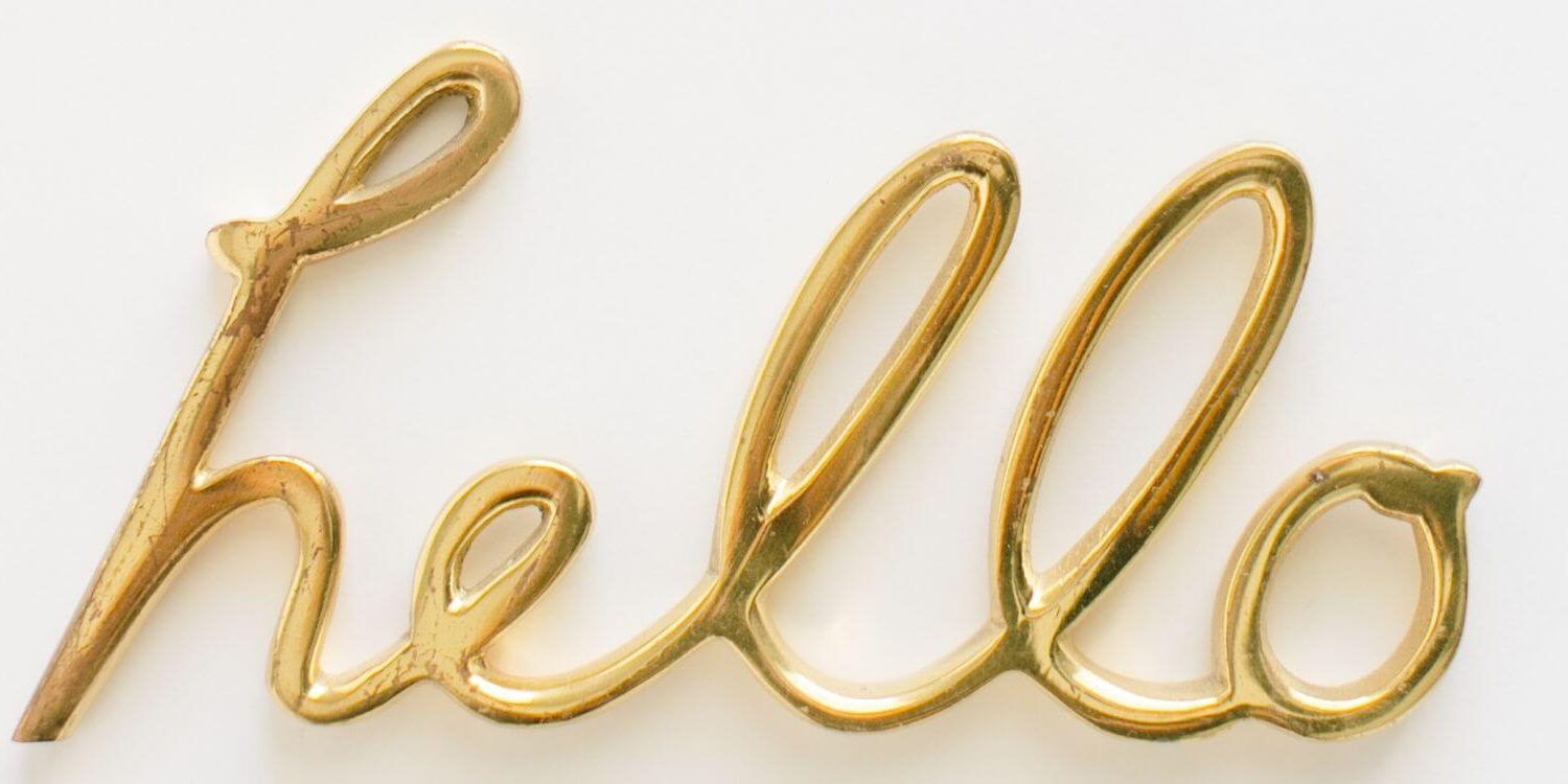 gold balloon letters spelling out the word hello on a white background