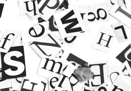 black and white letters in different type styles and fonts scattered on a white table