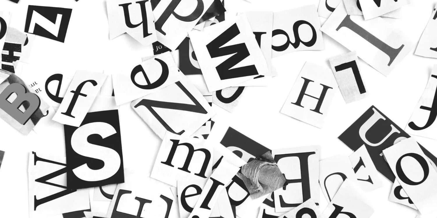 black and white letters in different type styles and fonts scattered on a white table