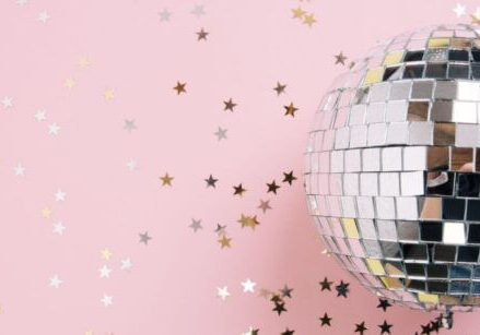 pink background with star confetti and a disco ball - stop getting distracted with shiny object syndrome