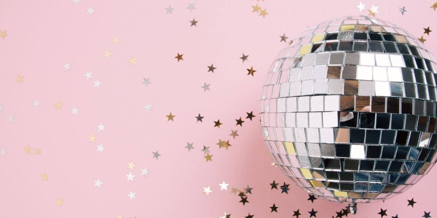 pink background with star confetti and a disco ball - stop getting distracted with shiny object syndrome