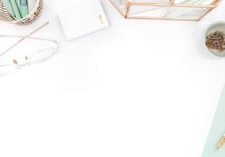 mint green desk accessories flat lay on a white background